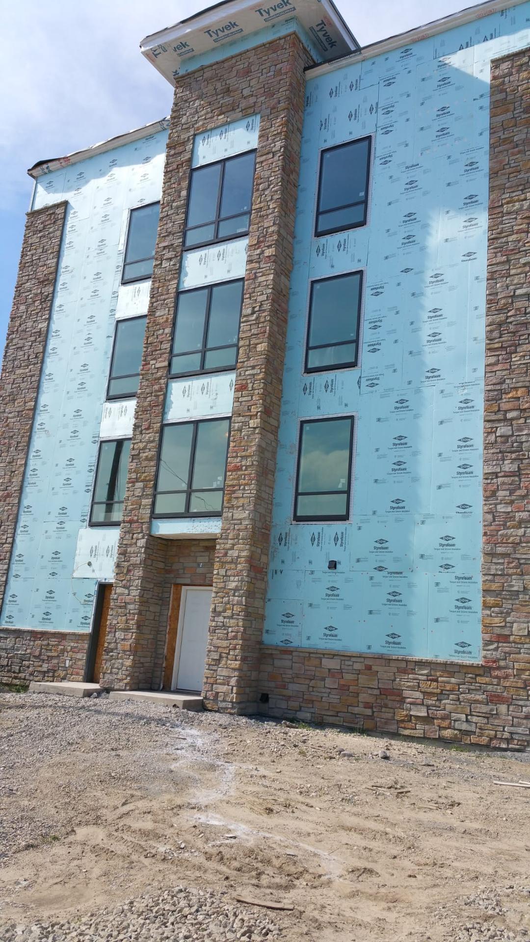 Commercial building with partial siding and stone veneer