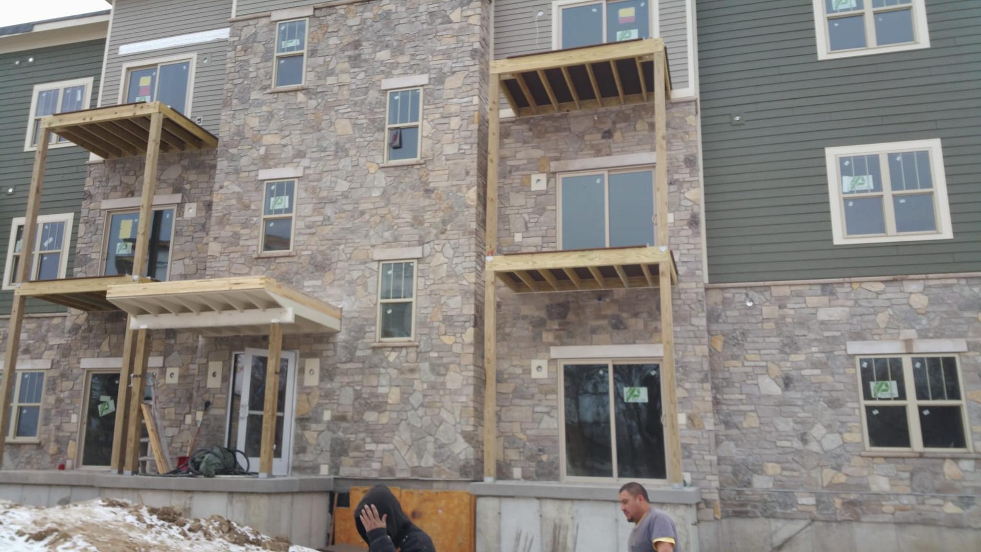 Apartment building with stone and siding exterior