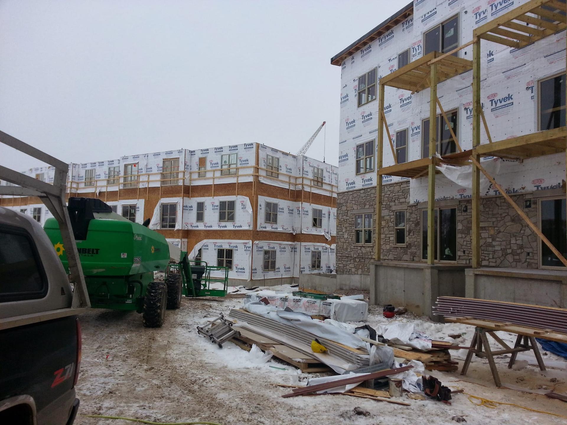 Winter jobsite with multi-family framing and siding