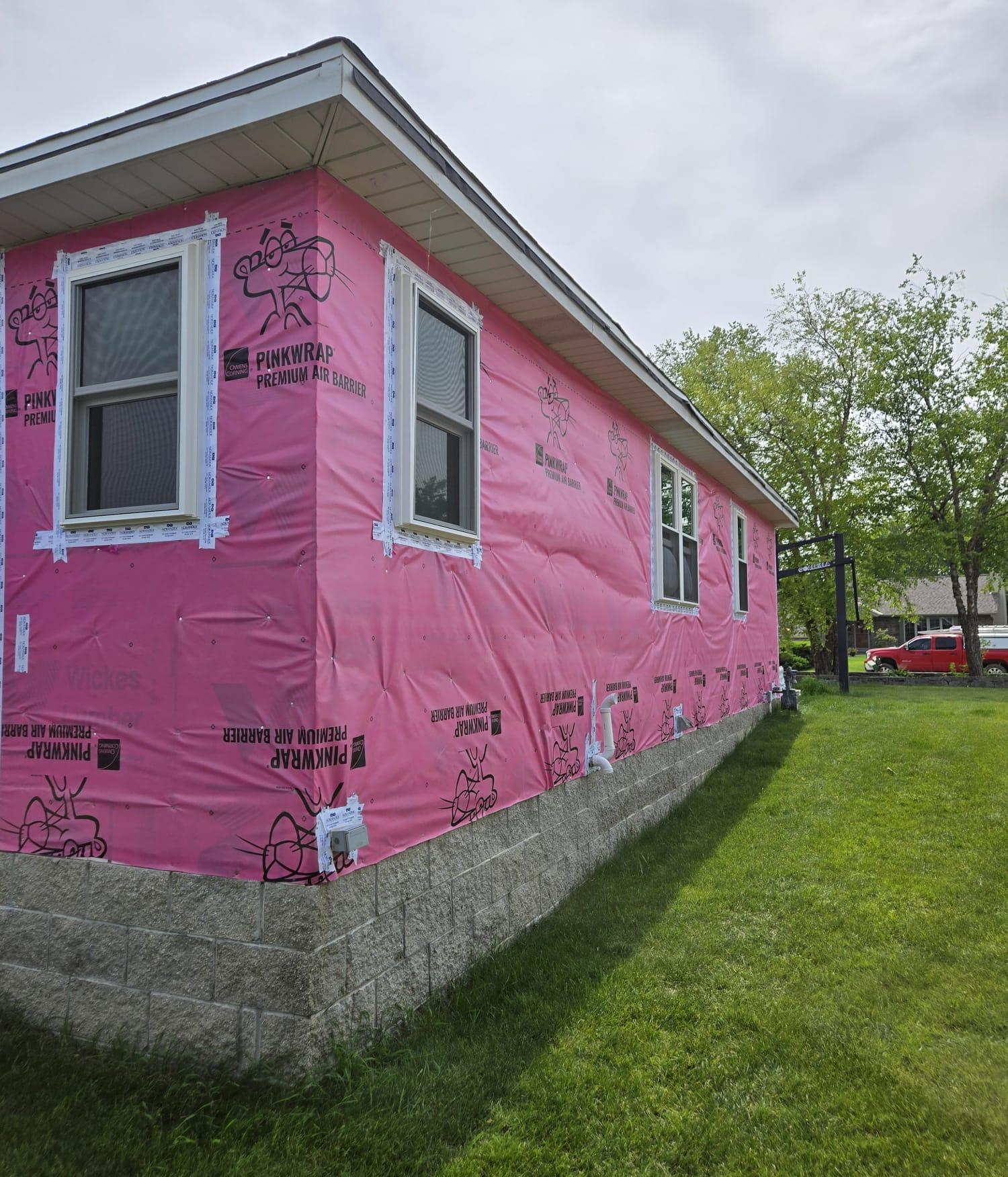 Residential siding in progress with house wrap